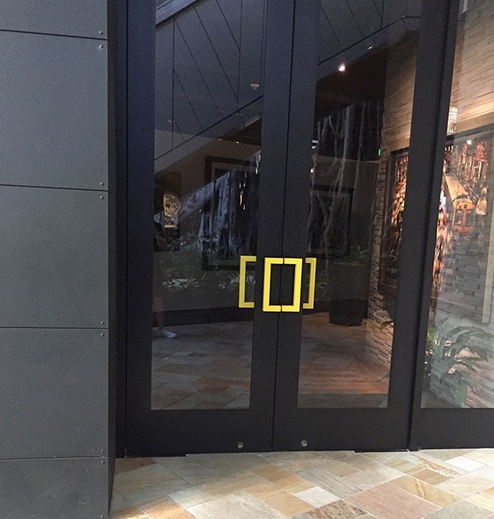 Drzwi do galerii National Geographic posiadają klamkę będącą logo tej firmy.