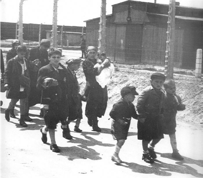 3. Żydowskie dzieci trzymające się za ręce, nieświadomie zmierzając ku swojej śmierci w jednej z komór gazowych w oświęcimskim obozie zagłady.