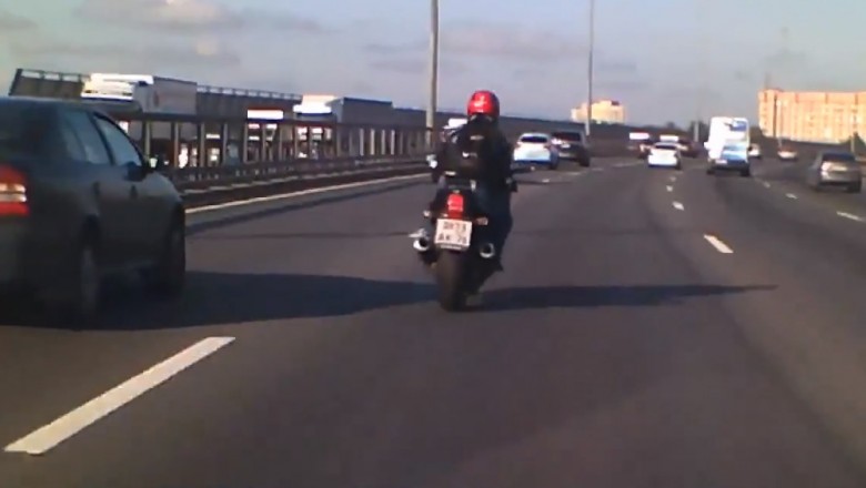 Kierowca samochodu osłania motocyklistę na drodze szybkiego ruchu. Super postawa