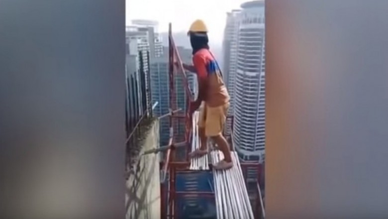 BHP? Jakie BHP?! Malezyjski pracownik używający metalowych rur jako rusztowania